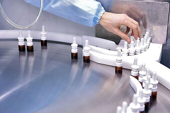 A man works in a pharmaceutical factory. Visual monitoring of the quality of interferon production. Sterile hormone production line.