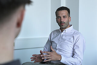 Ein sitzender Mann im Gespräch