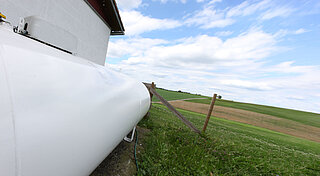 Flüssiggastank auf einem Bauernhof neben Feld